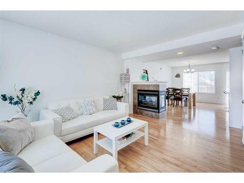 50 Prestwick Rise Se, Calgary, AB - Indoor Photo Showing Living Room With Fireplace