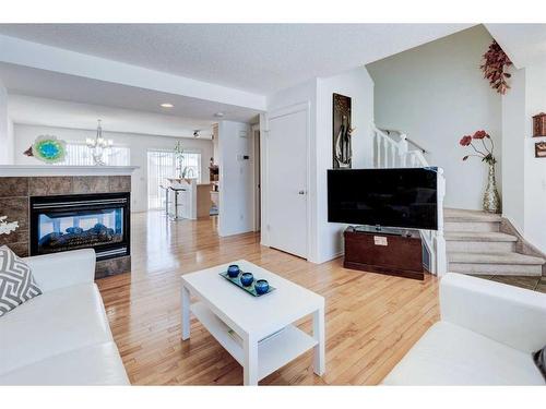 50 Prestwick Rise Se, Calgary, AB - Indoor Photo Showing Living Room With Fireplace