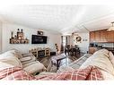 484 Queen Charlotte Road Se, Calgary, AB  - Indoor Photo Showing Living Room 