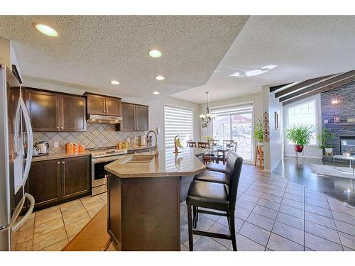 602 Kincora Bay Nw, Calgary, AB - Indoor Photo Showing Kitchen With Fireplace With Upgraded Kitchen