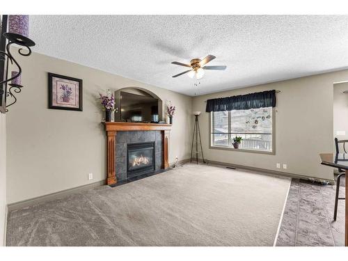 233 Bridlemeadows Common Sw, Calgary, AB - Indoor Photo Showing Living Room With Fireplace