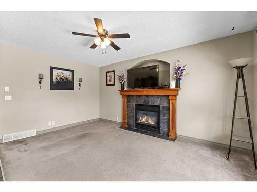 233 Bridlemeadows Common Sw, Calgary, AB - Indoor Photo Showing Living Room With Fireplace