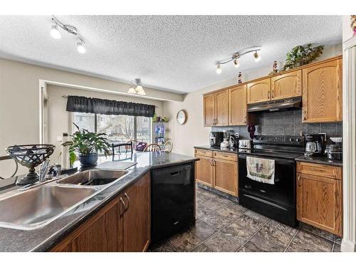 233 Bridlemeadows Common Sw, Calgary, AB - Indoor Photo Showing Kitchen With Double Sink