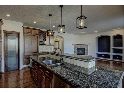 112 Brightonstone Bay Se, Calgary, AB - Indoor Photo Showing Kitchen With Fireplace With Double Sink