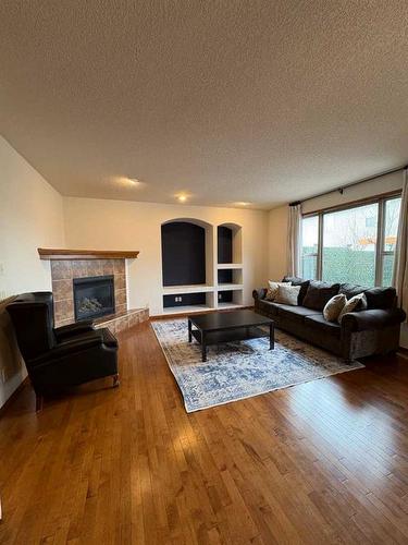 112 Brightonstone Bay Se, Calgary, AB - Indoor Photo Showing Living Room With Fireplace