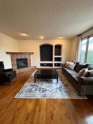 112 Brightonstone Bay Se, Calgary, AB - Indoor Photo Showing Living Room With Fireplace