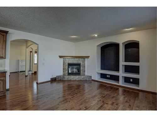 112 Brightonstone Bay Se, Calgary, AB - Indoor Photo Showing Living Room With Fireplace