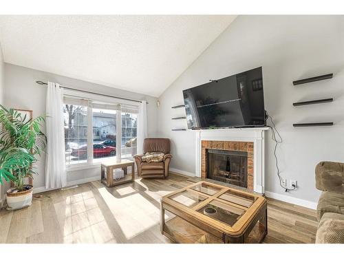 68 Templemont Drive Ne, Calgary, AB - Indoor Photo Showing Living Room With Fireplace