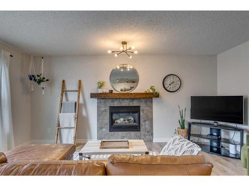 39 Chapalina Way Se, Calgary, AB - Indoor Photo Showing Living Room With Fireplace