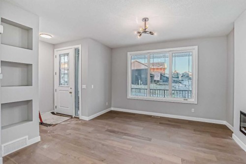 23 Agate Road, Cochrane, AB - Indoor Photo Showing Other Room With Fireplace