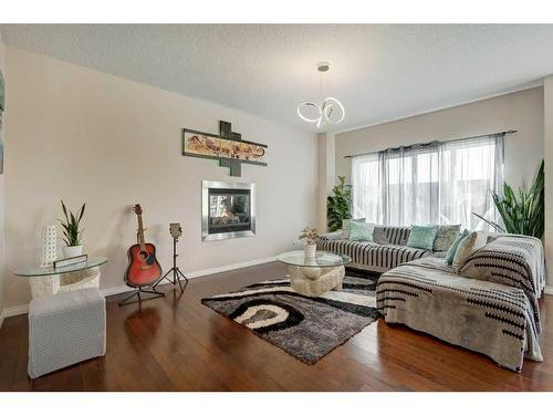 129 Walden Crescent Se, Calgary, AB - Indoor Photo Showing Living Room With Fireplace