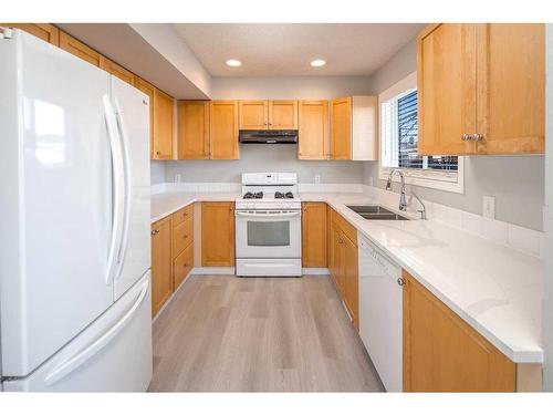 196 Bridleridge Gardens Sw, Calgary, AB - Indoor Photo Showing Kitchen With Double Sink