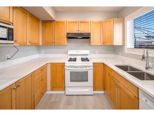 196 Bridleridge Gardens Sw, Calgary, AB - Indoor Photo Showing Kitchen With Double Sink