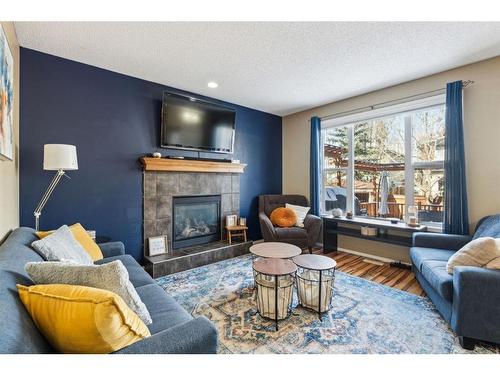 266 Cranwell Bay Se, Calgary, AB - Indoor Photo Showing Living Room With Fireplace