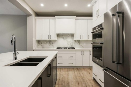173 Edith Place Nw, Calgary, AB - Indoor Photo Showing Kitchen With Stainless Steel Kitchen With Double Sink With Upgraded Kitchen