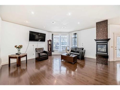 16 Rockcliff Point Nw, Calgary, AB - Indoor Photo Showing Living Room With Fireplace