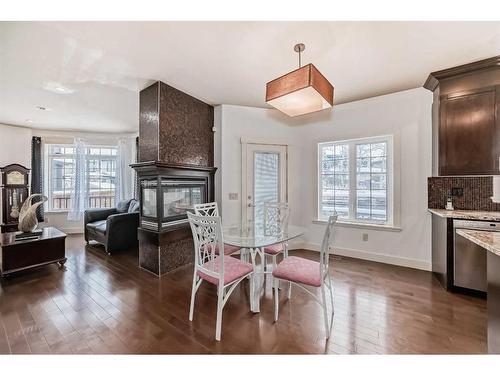 16 Rockcliff Point Nw, Calgary, AB - Indoor Photo Showing Dining Room With Fireplace