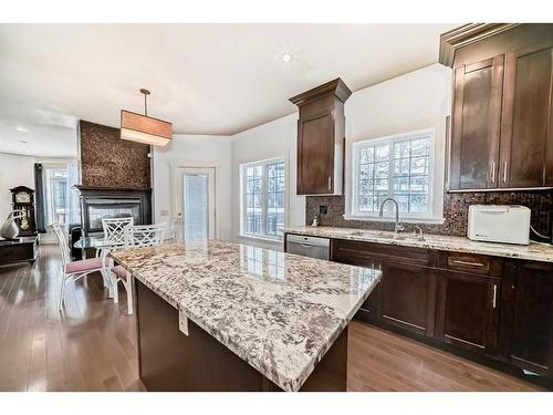 16 Rockcliff Point Nw, Calgary, AB - Indoor Photo Showing Kitchen With Fireplace With Upgraded Kitchen