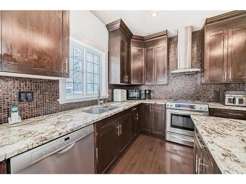 16 Rockcliff Point Nw, Calgary, AB - Indoor Photo Showing Kitchen With Stainless Steel Kitchen With Double Sink With Upgraded Kitchen