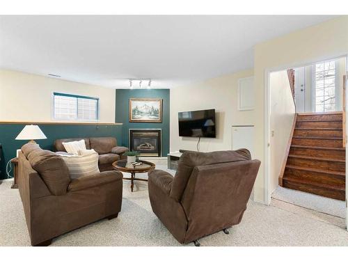 81 Shawinigan Road Sw, Calgary, AB - Indoor Photo Showing Living Room With Fireplace