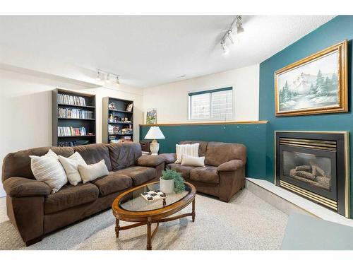 81 Shawinigan Road Sw, Calgary, AB - Indoor Photo Showing Living Room With Fireplace