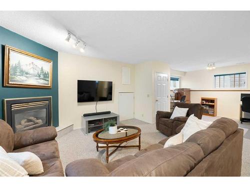 81 Shawinigan Road Sw, Calgary, AB - Indoor Photo Showing Living Room With Fireplace