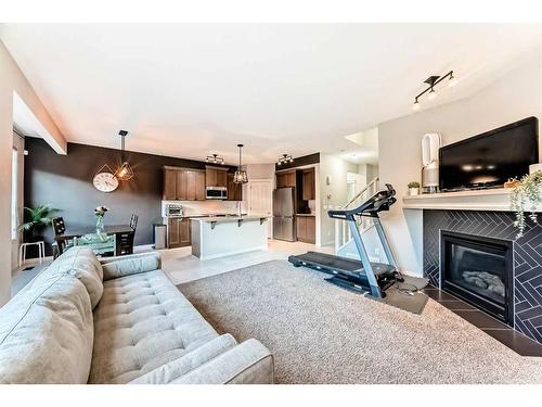 222 Cranston Gate Se, Calgary, AB - Indoor Photo Showing Living Room With Fireplace