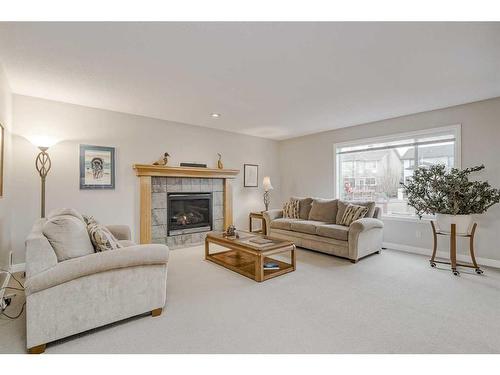 10 Cougarstone Terrace Sw, Calgary, AB - Indoor Photo Showing Living Room With Fireplace