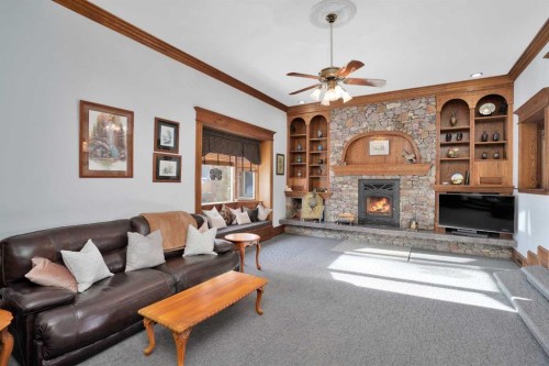 31027 Range Road 50, Rural Mountain View County, AB - Indoor Photo Showing Living Room With Fireplace
