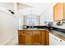 106 Covehaven View, Calgary, AB  - Indoor Photo Showing Kitchen With Double Sink 