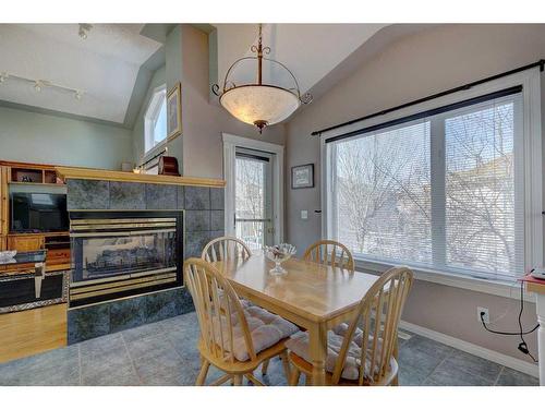 4 Evergreen Way Sw, Calgary, AB - Indoor Photo Showing Dining Room With Fireplace