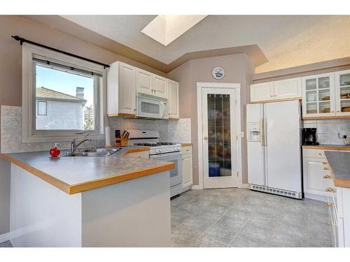 4 Evergreen Way Sw, Calgary, AB - Indoor Photo Showing Kitchen With Double Sink