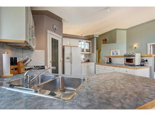 4 Evergreen Way Sw, Calgary, AB - Indoor Photo Showing Kitchen With Double Sink