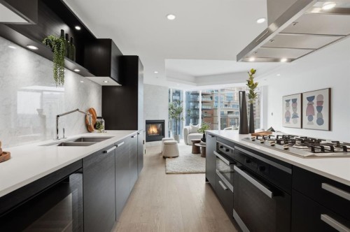 907-738 1 Avenue Sw, Calgary, AB - Indoor Photo Showing Kitchen With Fireplace With Double Sink