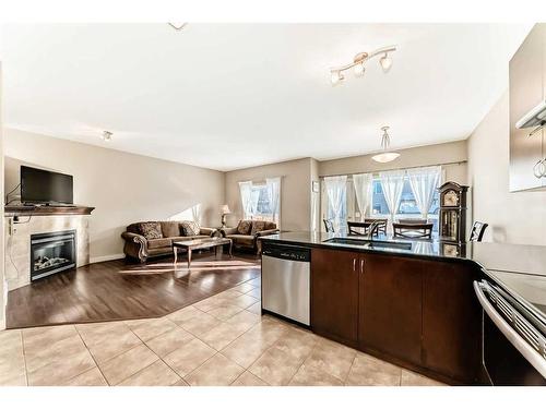 50 Everwoods Link Sw, Calgary, AB - Indoor Photo Showing Kitchen With Fireplace