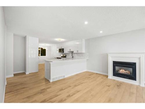 92 Templeby Road Ne, Calgary, AB - Indoor Photo Showing Living Room With Fireplace