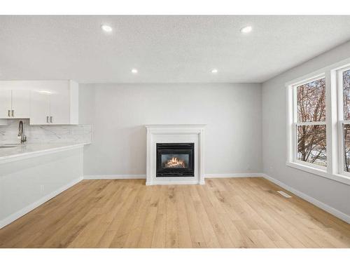 92 Templeby Road Ne, Calgary, AB - Indoor Photo Showing Living Room With Fireplace