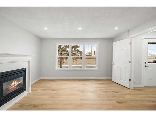 92 Templeby Road Ne, Calgary, AB - Indoor Photo Showing Living Room With Fireplace