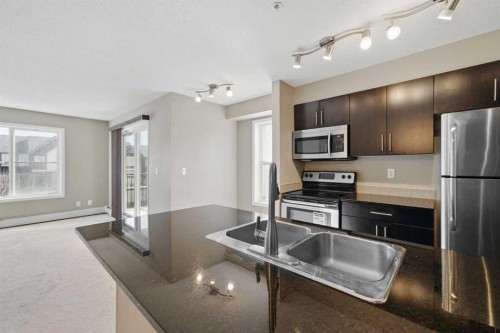 1240-81 Legacy Boulevard Se, Calgary, AB - Indoor Photo Showing Kitchen With Stainless Steel Kitchen With Double Sink