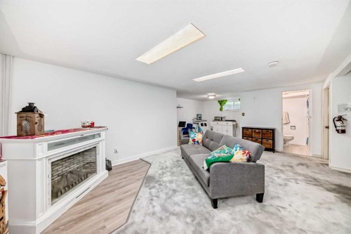 708 75 Avenue Sw, Calgary, AB - Indoor Photo Showing Living Room With Fireplace