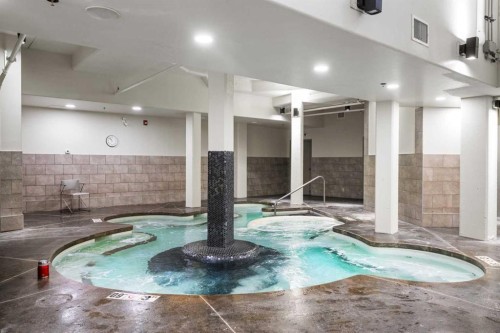 407-187 Kananaskis Way, Canmore, AB - Indoor Photo Showing Other Room With In Ground Pool