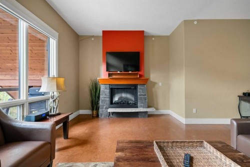 407-187 Kananaskis Way, Canmore, AB - Indoor Photo Showing Living Room With Fireplace