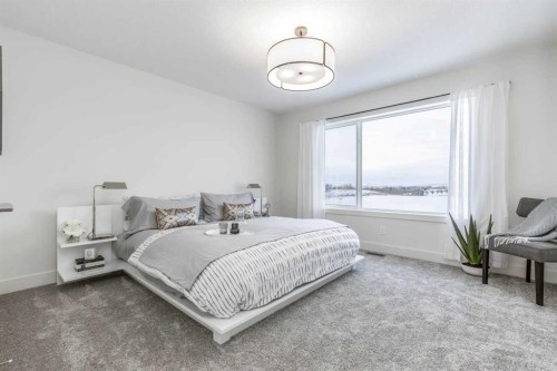 84 Emberside Green, Cochrane, AB - Indoor Photo Showing Bedroom