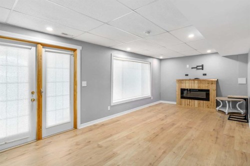 181 Hidden Creek Gardens Nw, Calgary, AB - Indoor Photo Showing Other Room With Fireplace