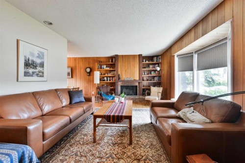 5712 Layzell Road Sw, Calgary, AB - Indoor Photo Showing Living Room With Fireplace