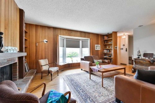 5712 Layzell Road Sw, Calgary, AB - Indoor Photo Showing Living Room With Fireplace