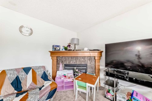 45 Shawbrooke Park Sw, Calgary, AB - Indoor Photo Showing Living Room With Fireplace