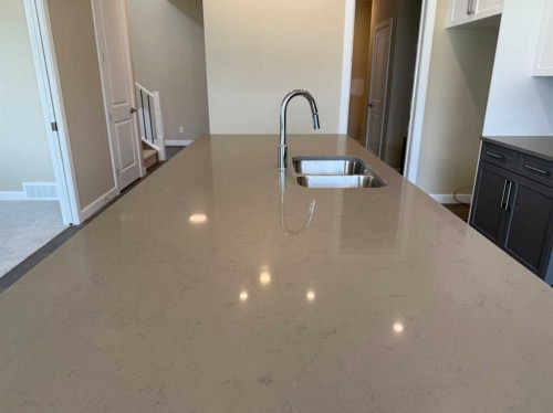 91 Sundown Crescent, Cochrane, AB - Indoor Photo Showing Kitchen With Double Sink
