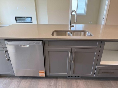 91 Sundown Crescent, Cochrane, AB - Indoor Photo Showing Kitchen With Double Sink
