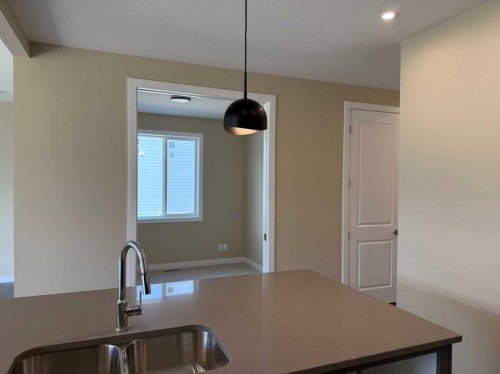 91 Sundown Crescent, Cochrane, AB - Indoor Photo Showing Kitchen With Double Sink